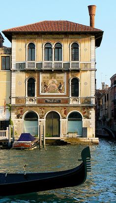 a gondola on the water in front of a building