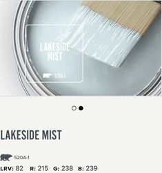 a white paint can with a brush in it and the words lakeside mist above it