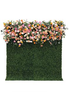 an artificial wall with flowers growing on it