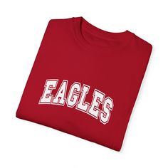 Show your Eagles pride with this classic t-shirt featuring bold, collegiate-style lettering. Perfect for game days, school events, or everyday wear, this tee lets you confidently represent your team. The clean and straightforward design makes it a versatile addition to any fan’s wardrobe. Cheer on the Eagles in style, and let everyone know who you’re supporting with this timeless team t-shirt. University Red T-shirt With Team Name For Fans, College Fan Apparel T-shirt With Team Name, Collegiate Game Day T-shirt With Team Name, Varsity T-shirt With Team Logo For Football Season, College Football Season Team Logo T-shirt, Collegiate T-shirt With University Logo For Game Day, College Football Season T-shirt With Team Logo, College Sports Season Logo Print T-shirt, College Sports Season T-shirt With Logo Print