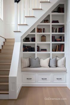 a room with some bookshelves and stairs in it