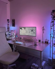 a white chair sitting in front of a computer desk