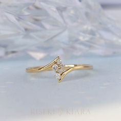 a diamond ring sitting on top of a white surface