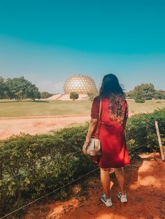 a woman in a red dress is looking at the ballon d'ord