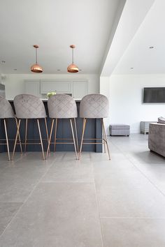 a living room filled with furniture and a flat screen tv mounted to the side of a wall