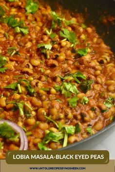 a pan filled with beans and cilantro on top of a stove