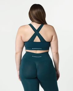 HIGHLIGHTS. Removable cups. Scrunch detailing in the center. Medium to high impact. Moisture-wicking, breathable fabric. V-shaped neckline and crossing back straps. Unbelievably soft texture. Proprietary seamless blend of fine Italian yarn. Alphalete core wordmark knitted in white. Reinforced binding arm and neckline finishing FIT SUGGESTION. This item has a compression fit.. If you are between sizes, we recommend sizing up.. Model is 5’11”/180.3cm, wearing a size L with a 42.5”/108cm bust.. MAT Seamless Medium Support Sports Bra With Cross Back, Bra-friendly Fitted Cross Back Activewear, Nylon Activewear With Cross Back And Bra Friendly Design, Seamless Cross Back Gym Activewear, Seamless Cross Back Activewear For Gym, Medium Support Seamless Cross Back Sports Bra, Medium Support Seamless Sports Bra With Cross Back, High Stretch Seamless Cross Back Sports Bra, Medium Support Seamless Cross-back Sports Bra