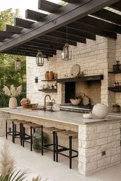 an outdoor kitchen with stone and brick walls