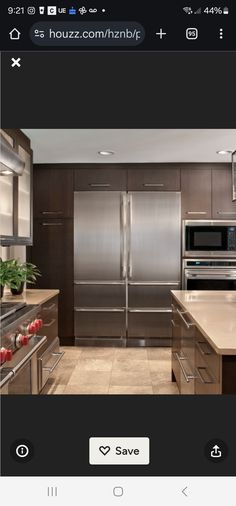 a kitchen with stainless steel appliances and wood cabinetry, including an appliance