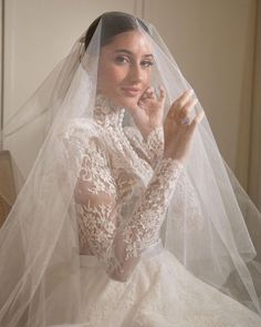 a woman in a white wedding dress and veil