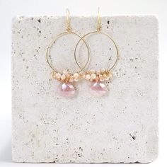 Free Shipping on our lightweight, peach moonstone gold hoop dangle earrings. Handmade wire-wrapped earrings are made with genuine moonstones in a gorgeous pale peachy-pink shade.Accent stones are peach moonstone and champagne quartz- 2.25” long- French hooks- 14k gold plated fine Italian sterling silver- Made in the USA in our New York City studio- Arrives in a gift boxCustom shapes and real gemstones make each pair one-of-a-kindWe always offer FREE SHIPPING on orders in the United States.Whethe Delicate Wire Wrapped Dangle Hoop Earrings, Pink 14k Gold-filled Wire Wrapped Earrings, Delicate Wire Wrapped Round Earrings, Pink Wire Wrapped Round Hoop Earrings, Pink Wire Wrapped Hoop Earrings, Hoop Dangle Earrings, Gemstone Hoop Earrings, Wrapped Earrings, Pink Shade