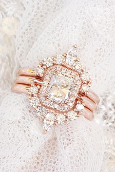 a close up of a ring on top of a white lace