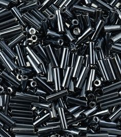 many black and silver screws are scattered together