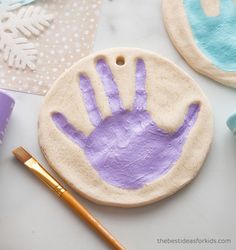 some crafting supplies are laying out on a table with handprints and paint