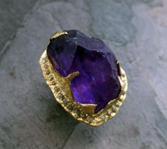 Raw Rough Uncut Amethyst Diamonds 18k Gold Halo Ring Statement ring Show Stopper ring byAngelineRaw rough uncut AAA quality amethyst surrounded by lovely conflict free raw rough diamonds. I hand carved this ring in wax and cast it in solid 18k gold using the lost wax casting process. The diamonds were cast in place. This one of a kind raw gemstone ring is a size 6 1/4 and it can be stretched to a 7. The high quality amethyst stone measures about 25mm X 18mm X 18MM. The ring measure 31mm X 25mm w Amethyst Jewelry Ring, Rose Gold Halo Ring, Gold Halo Ring, 14k Gold Wedding Ring, Raw Gemstone Ring, Woman Jewelry, Morganite Diamond, Gold Halo, Resin Ring