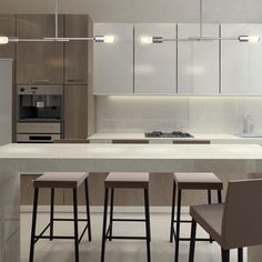 a modern kitchen with an island and bar stools