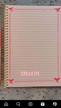 an open notebook with the word coquette written in pink on it next to a pen