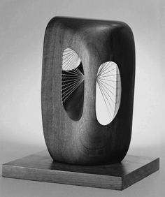 a black and white photo of an object on a wooden stand with two fan shaped sections