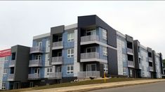 an apartment building with balconies on the second floor