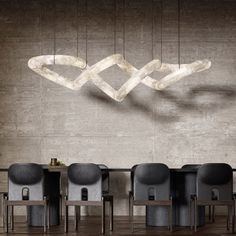 a modern chandelier hanging over a dining room table