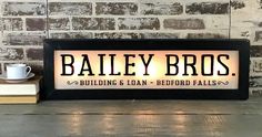 a sign that says bailey bros on it next to a coffee cup and some books