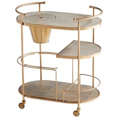 a gold metal and wood serving cart with two trays on wheels, one holding a vase