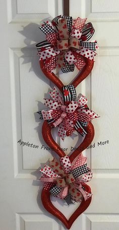 a heart shaped wreath hanging on the front door