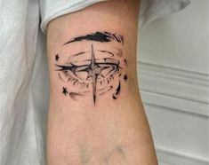 a black and white photo of a compass tattoo