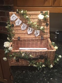 a wicker basket with flowers and letters on it