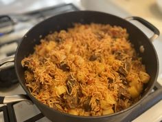 a pan filled with food sitting on top of a stove next to a burner