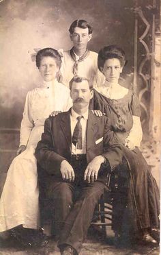 an old black and white photo of a family posing for a portrait in the early 1900's