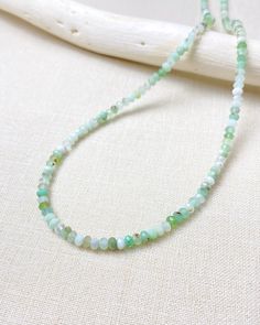 Enjoy the soft glowing colors of this chrysoprase beaded necklace. Small micro-faceted chrysoprase beads are hand-strung to create this simple yet eye-catching necklace. These petite gems display varying shades of green, creating an earthy elegance. Chrysoprase is an alternative birthstone for May. Designed as a part of our Birthstone Bar Collection, all of our birthstone charms will slip easily onto this slim necklace, allowing you to create your own unique piece. Add your birthstone or those o Green Aventurine Beaded Hand-strung Necklace, Green Onyx Beaded Necklaces With Round Beads, Faceted Jade Round Bead Necklace, Green Aventurine Crystal Necklaces With Round Beads, Green Amazonite Round Beads Necklaces, Green Hand-strung Crystal Necklaces For Healing, Green Hand-strung Crystal Necklace For Healing, Healing Green Onyx Beaded Necklaces, Spiritual Green Amazonite Beaded Necklaces