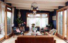 a living room filled with furniture and lots of windows