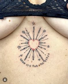 a woman's back with an arrow and heart tattoo on her left side ribcage