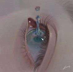 an eye with long lashes is reflected in the water that has been created into a heart shape