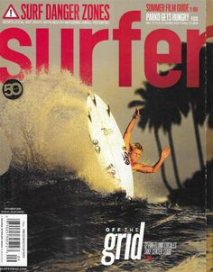 a man riding a surfboard on top of a wave in the ocean next to palm trees