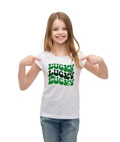 "Dress up your little girl for St. Patrick's Day with this retro Lucky St. Patricks Day t-shirt! This St. Patrick's Day shirt for girls are 100% cotton and are created using heat pressed vinyl. They are available in both onesies and t-shirts. The t-shirts are available in black, green, and white. The onesie's are only available in white. We have the following sizes available: Newborn (Up to 21.5\" Height / 5 - 8lbs) 3 Months (21.5\" - 24\" Height / 8 - 12.5lbs) 6 Months (24\" - 26.5\" Height / 1 St Patricks Shirt, Vinyl Dress, St Patricks Day Shirt, White Onesie, Lucky Shirt, Halloween Bags, Heat Press Vinyl, St Patrick Day Shirts, Saint Patrick