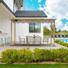 an outdoor dining area next to a swimming pool