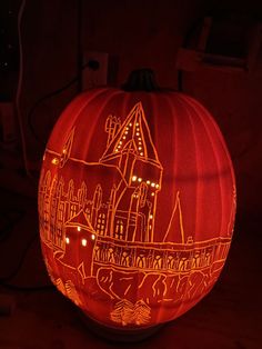 a carved pumpkin with an image of a castle on it's front and side