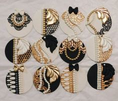 many different types of necklaces are shown on a white sheet with black and gold accents