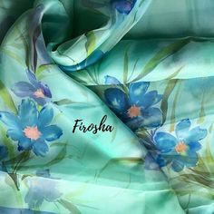 a blue flowered scarf with the word fursha written in black ink on it