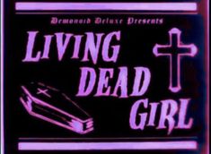 a neon sign that says living dead girl with a cross and book on the front