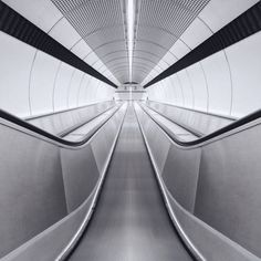 an abstract photo of the inside of a building with lines and curves in black and white