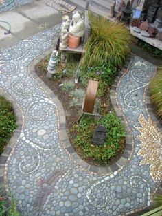 an outdoor garden with stone walkways and plants