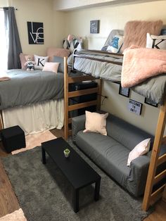 a bedroom with bunk beds and couches in the corner, on top of carpeted flooring