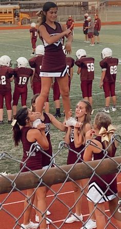 the cheerleaders are getting ready for their team's football game to start