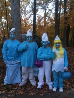 three people in blue and white costumes standing next to each other with their hands on their hipss