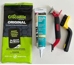 the contents of a grooming kit including toothbrush, comb and glue are laid out on a white surface