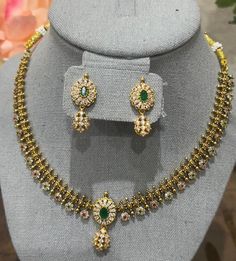 Enhance your beauty with this radiant gold-plated necklace, featuring a delicate design adorned with stunning green and white cubic zirconia (CZ) stones. Complemented by matching earrings, this set exudes elegance and grace, making it perfect for any special occasion. Features: *Design: Elegant gold-plated necklace with intricate detailing *Stones: Adorned with high-quality green and white CZ stones for a dazzling effect *Earrings: Matching earrings included to complete the set *Materials: Gold Elegant Gold Plated Green Jewelry Sets, Elegant Green Gold Plated Jewelry Sets, Elegant Green Gold-plated Jewelry Sets, Gold Plated Green Jewelry With 17 Jewels, Green Gold Plated Jewelry Set As A Gift, Green Gold Plated Jewelry Set For Gift, Green Gold-plated Jewelry Set For Gift, Formal Green Plated Jewelry, Gold Cubic Zirconia Necklace For Festive Occasions