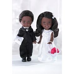 two dolls dressed in black and white holding hands